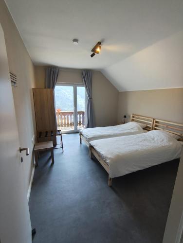 a bedroom with two beds and a balcony at Alpenhaus Claudia in Radenthein