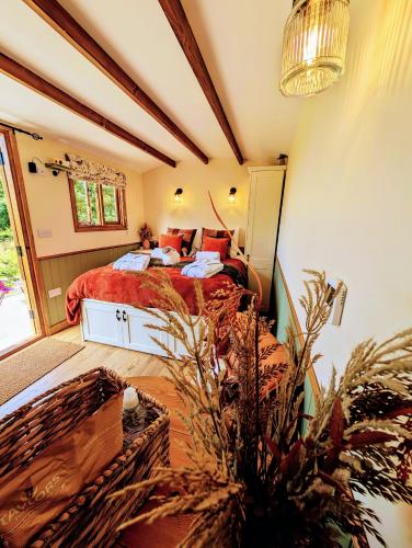 a bedroom with a bed and a large window at Lintmill Lodges - Heather Shepherds Hut in Sorn