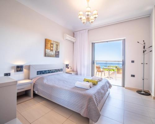 a bedroom with a bed and a view of the ocean at Villa Ilias in Skala