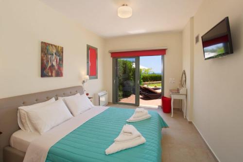 a bedroom with a bed with two towels on it at Trapezaki Bay Cottage in Trapezaki