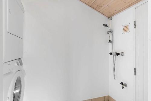 a bathroom with a washing machine in a room at LN1963-Hirtshals-Klynen-19 in Hirtshals