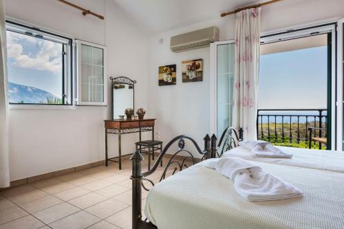 a bedroom with two beds and a window at Villa Zeus in Spartià