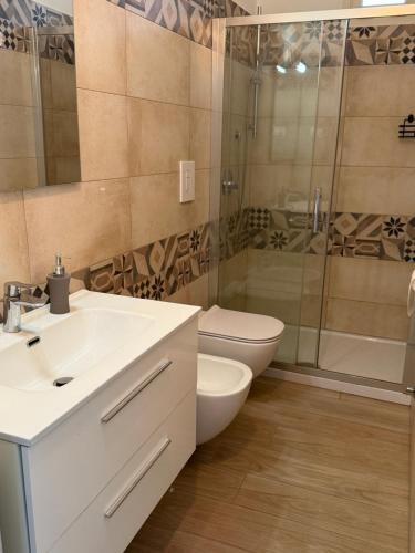 a bathroom with a toilet and a sink and a shower at B&B Casa Denittis in Peschici