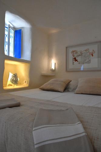 a bedroom with two large beds with a window at Dar Bibine in Erriadh
