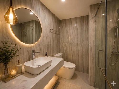 a bathroom with a sink and a toilet and a mirror at Vip villa in Phú Quốc