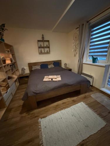 a bedroom with a bed with two towels on it at Apartman BibKa in Donovaly