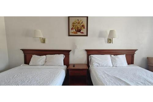 a hotel room with two beds and two lamps at Albuquerque Inn Near Airport I 40 in Albuquerque