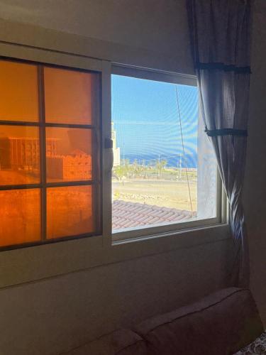 an open window with a view of the beach at v2 غرفة وصالة in Al Wajh