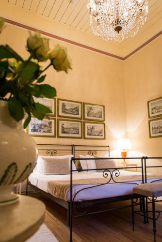 a bedroom with two beds and a chandelier at Castello di Lispida in Monselice