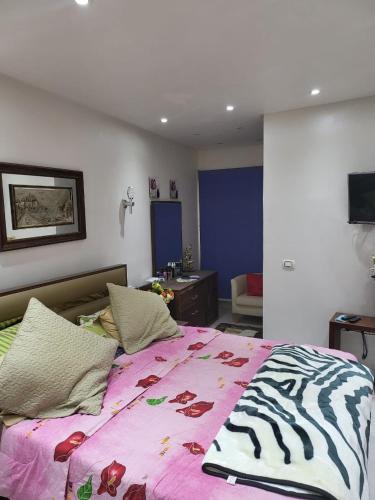 a bedroom with a bed with a zebra blanket on it at Nashwa m mohamed in Ain Sokhna