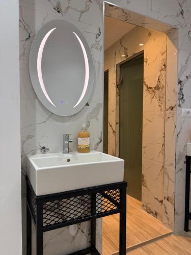 a bathroom with a white sink and a mirror at Bume's Hostel in Sarandë