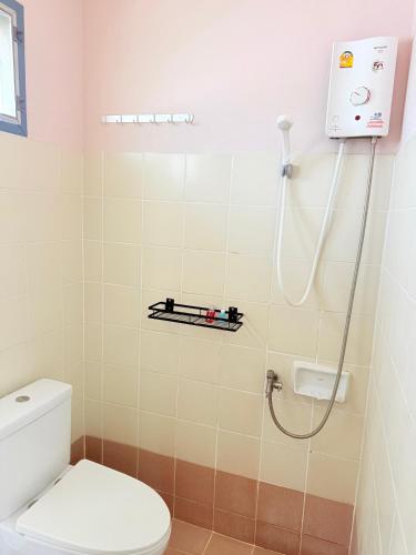 a bathroom with a toilet and a shower at Amaya Bloom Resort & Spa in Pattaya