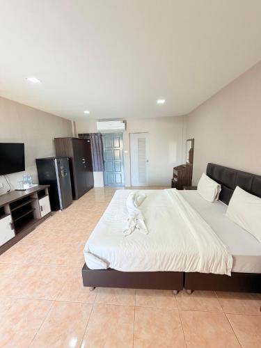 a large bedroom with a large bed and a television at Amaya Bloom Resort & Spa in Pattaya