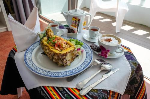 a table with a plate of food and a cup of coffee at ON Hotel Phuket - SHA in Karon Beach