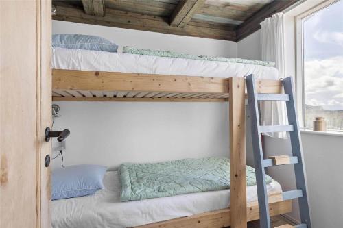 a bunk bed room with two bunk beds and a ladder at LN76158-Hjorring-Bredningen-18 in Hjørring
