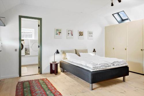 a bedroom with a bed and a mirror at LN1913-Hjorring-Rubjergvej-11 in Hjørring