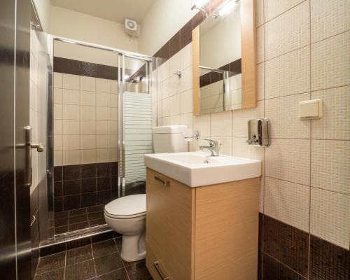 a bathroom with a toilet and a sink at Villa Joya by Villa Select in Skala