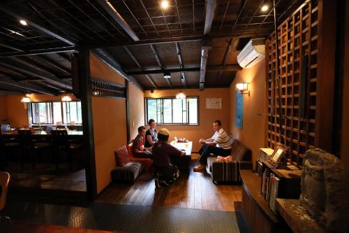 a group of people sitting in a room at Shima Onsen Kashiwaya Ryokan in Nakanojo