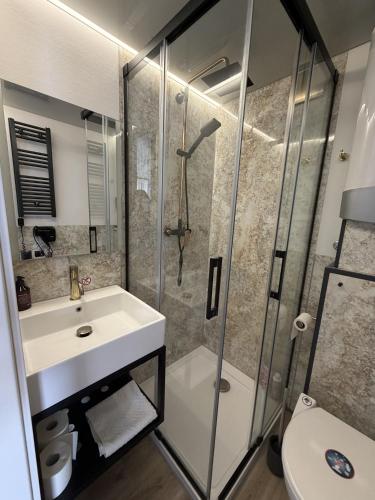 a bathroom with a sink and a shower at Design-Hausboot am Rheinsteig in Lorch am Rhein