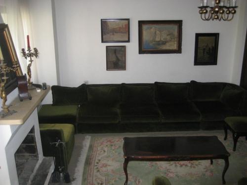 a living room with a black couch and a table at Apartments Colic in Herceg-Novi