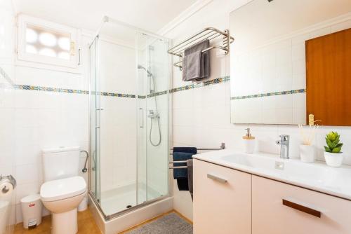 a bathroom with a shower and a toilet and a sink at Estrella Del Mar with Private Pool in Binibeca