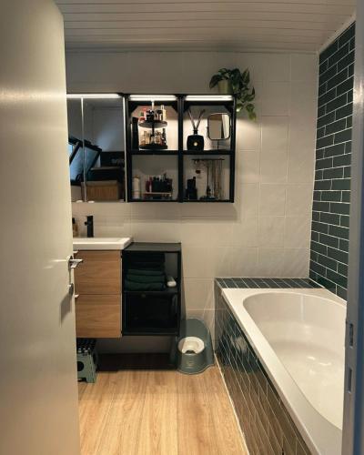 a bathroom with a tub and a sink and a bath tub at Jimy Hendrickx in Boom