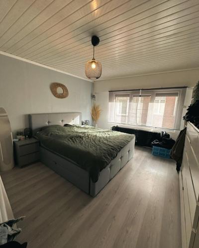 a bedroom with a bed and a wooden ceiling at Jimy Hendrickx in Boom