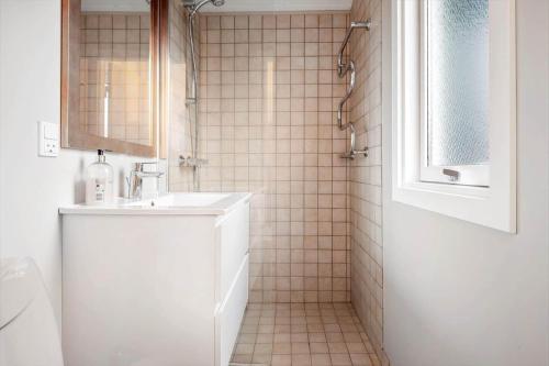a white bathroom with a sink and a mirror at LN2048-Hjorring-Havmanden-6 in Kærsgård Strand