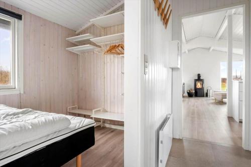 a bedroom with white walls and a bed in a room at LN2048-Hjorring-Havmanden-6 in Kærsgård Strand
