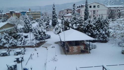 a city covered in snow with trees and buildings at Samdan Hotel in Pamukkale