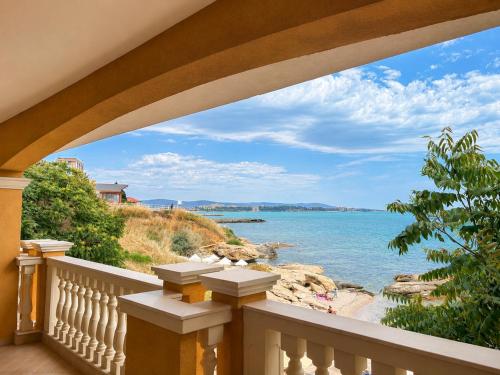a balcony with a view of the ocean at Santa Maria Luxury Suits in Ravda