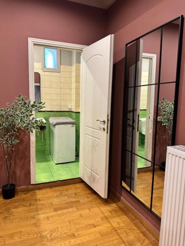 an open door to a room with a green floor at Nia The Nest in Nafpaktos