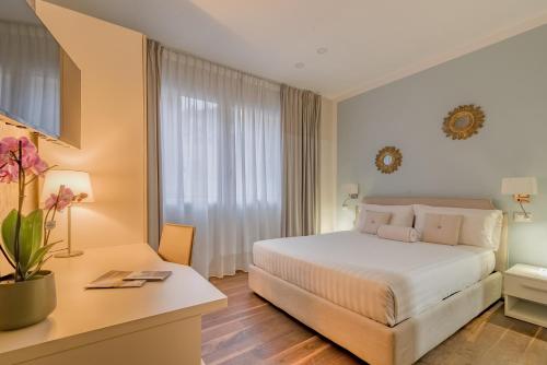 a hotel room with a bed and a desk at B&B H68 in Alassio