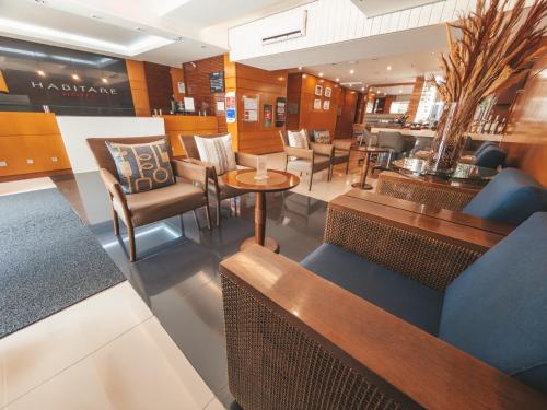 a restaurant with chairs and tables in a store at Hotel Habitare in Nova Friburgo