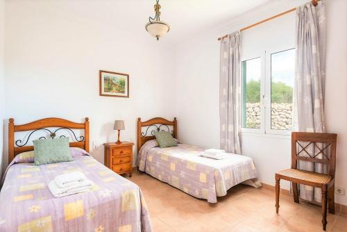 a bedroom with two beds and a window at Villa Son Domingo by Villa Select in Alaior