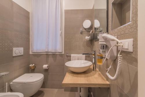 a bathroom with a sink and a toilet at B&B H68 in Alassio