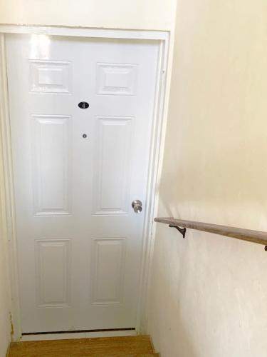 a white door in a room with a shelf at The Vista Inn Studio #4 in Falmouth