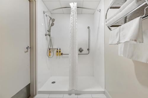 a shower with a glass door in a bathroom at Best Western Plus Dryden Hotel and Conference Centre in Dryden