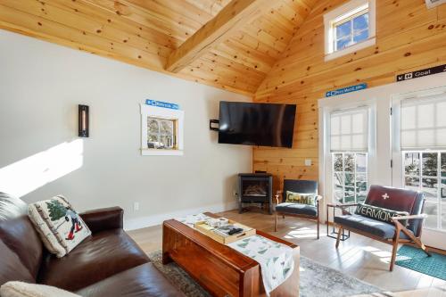 a living room with a couch and a flat screen tv at Maple Chalet in Morrisville