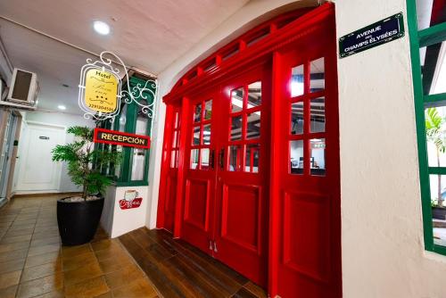 a red door in the side of a building at Boca Inn Hotel & Suites in Veracruz