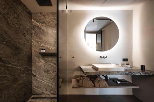 a bathroom with a sink and a mirror at Avita suites Ortisei in Ortisei