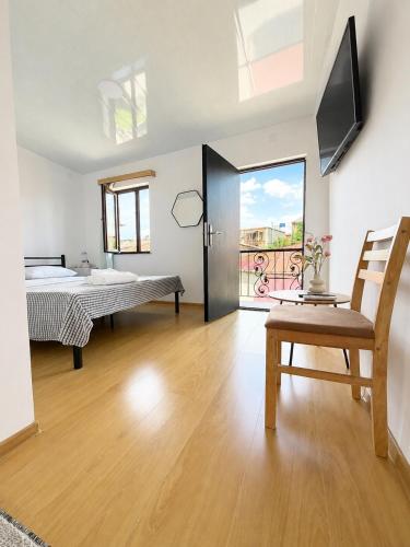 a bedroom with a bed and a television in a room at MaVi House in Kutaisi