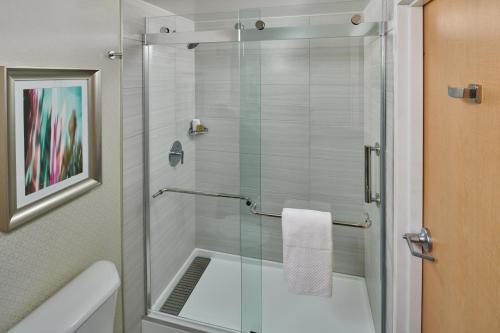 a shower with a glass door in a bathroom at DoubleTree by Hilton Irvine Spectrum in Irvine