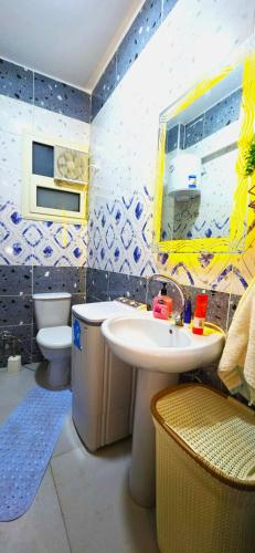 a bathroom with a sink and a toilet and a mirror at Solara in Hurghada