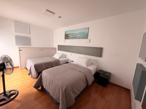 a bedroom with two beds and a fan at Barranco Boutique Hotel by 3B in Lima