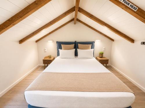 a bedroom with a large bed in a attic at Casa Enetiko in Chania