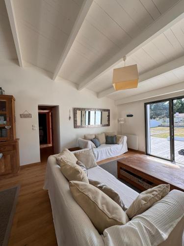 a living room with two couches and a couch at Maison de Vacances des Centaurées in La Guérinière