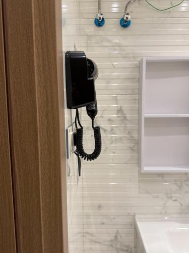 a phone is hanging on a wall in a bathroom at STAYs ستايز in Medina