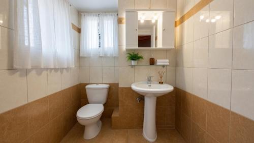 a bathroom with a toilet and a sink at Kalamata Penthouse By PAVLOS in Kalamata