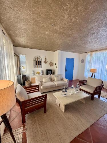 a living room with a couch and a table at Hotel Green en Marbella in Maitencillo